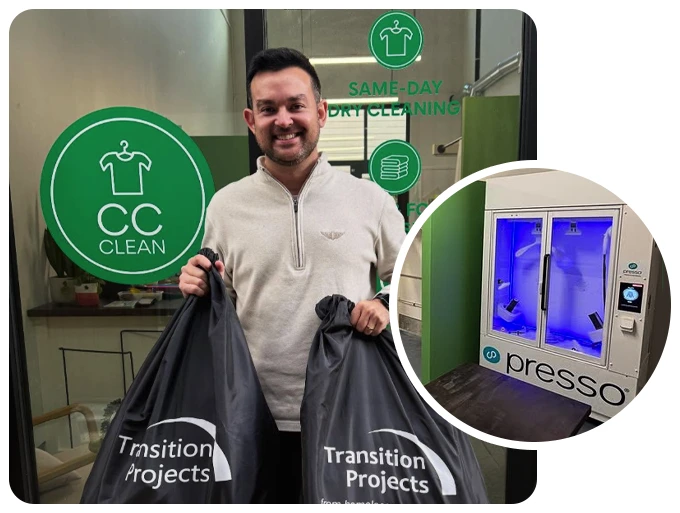 A man holds two laundry bags labeled "Transition Projects" in front of a dry cleaning shop. An inset shows a Presso garment cleaning machine.